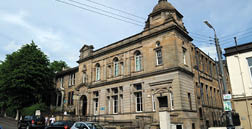 A large building with many windows and a clock tower. AI generated content