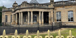 A large building with a black fence in front of it. AI generated content