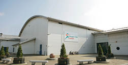 A large white building with a blue sign on the side. AI generated content