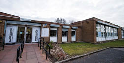 A large brick building with a black and white sign on the front. AI generated content