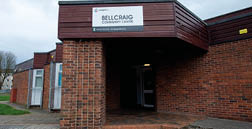 A brick building with a brown roof and a brown sign on the side. AI generated content