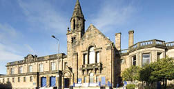 A large building with a clock tower and a steeple. AI generated content